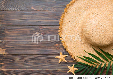 Summer holidays. Summer concept with straw hat and tropical leaf. Flat lay, top view, copy space Summer holidays. Summer concept with straw hat and tropical leaf. Flat lay, top view, copy space 89474687