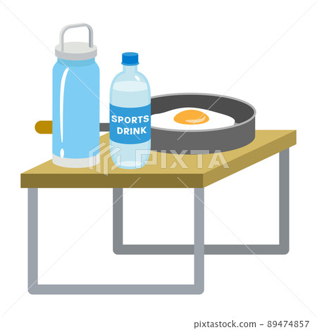 A frying pan with drinks and fried eggs on a low table 89474857