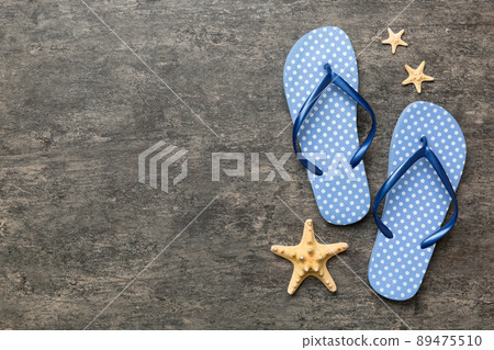 Flat lay composition with flip flops and seashell on colored background. Space for text top view Flat lay composition with flip flops and seashell on colored background. Space for text top view 89475510