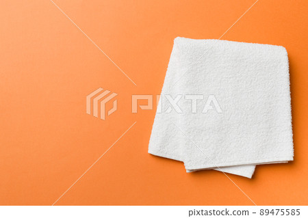 Top view of white towels with copy space on colored background 89475585
