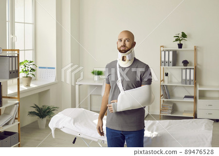 Portrait of sad man with neck brace and sling on his arm who was injured after car accident. Portrait of sad man with neck brace and sling on his arm who was injured after car accident. 89476528
