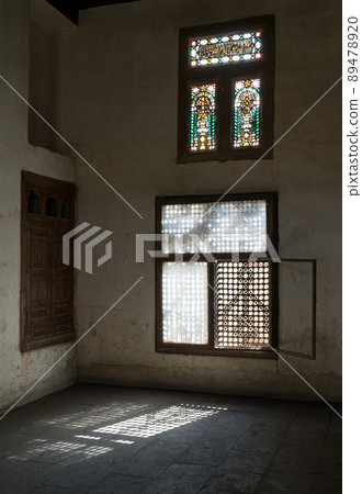 Old abandoned dark damaged dirty room with two wooden broken ornate windows Old abandoned dark damaged dirty room with two wooden broken ornate windows 89478920