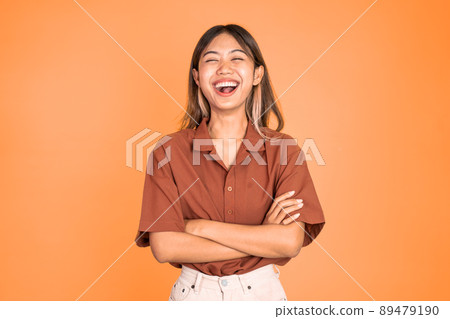 asian ethnicity female looking at camera smiling with crossed arm asian ethnicity female looking at camera smiling with crossed arm 89479190