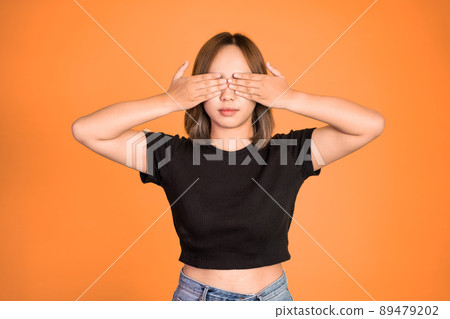 woman closing eyes with both palms on isolated background woman closing eyes with both palms on isolated background 89479202