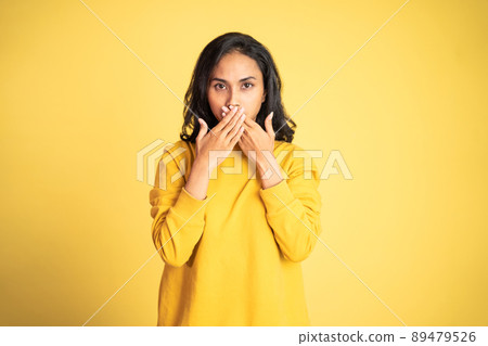 portrait of asian woman covering her mouth with hands 89479526
