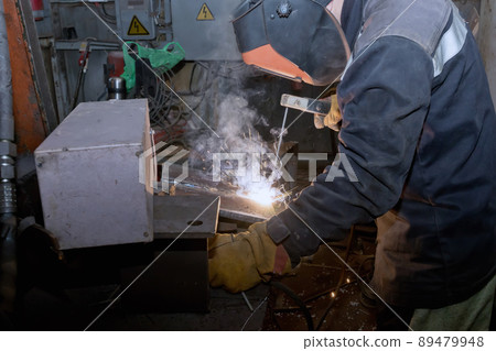 Welder in workshop conditions sample weld from sheet metal to undergo certification Welder in workshop conditions sample weld from sheet metal to undergo certification 89479948
