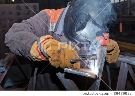 Welder in workshop conditions sample weld from sheet metal to undergo certification Welder in workshop conditions sample weld from sheet metal to undergo certification 89479952