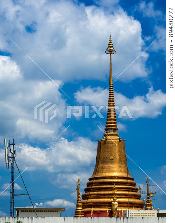 The golden pagoda is located in the city, towering to the sky 89480272