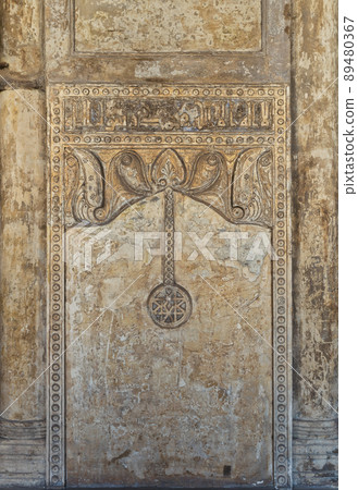 Ornate stone wall with floral patterns and calligraphy, Ibn Tulun Mosque, Cairo, Egypt Ornate stone wall with floral patterns and calligraphy, Ibn Tulun Mosque, Cairo, Egypt 89480367