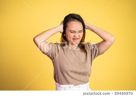 frustrated Asian young woman holding head with headache frustrated Asian young woman holding head with headache 89480970
