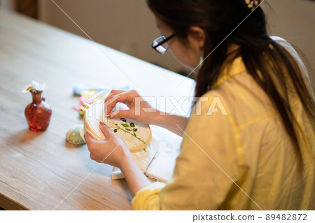 Woman embroidering 89482872