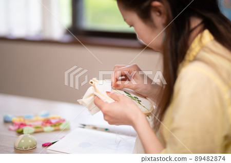 Woman embroidering 89482874