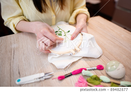 Woman embroidering 89482877