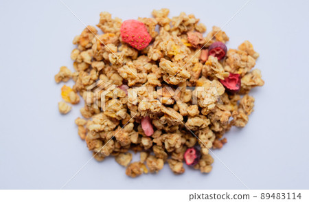 Close-up of granola, breakfast dish, snack. On the photo is a granule of oatmeal, honey and berries. 89483114