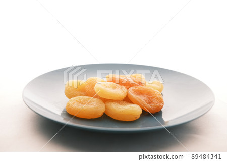 Apricot fruit half on wooden board on table  89484341