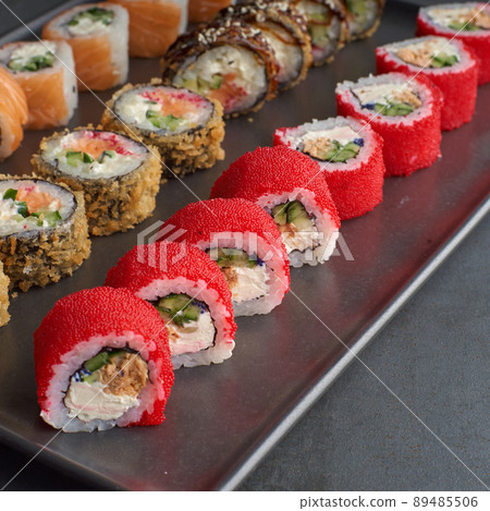 Sushi set. Roll Philadelphia, California Black, with fresh ingredients on stone background. 89485506