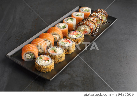 Sushi set. Roll Philadelphia, Tempura Salmon, with fresh ingredients on stone background. 89485509