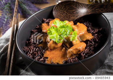 Thai red curry with chicken and black rice. 89485943