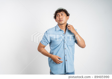 unsure asian young man thinking on isolated background unsure asian young man thinking on isolated background 89485990