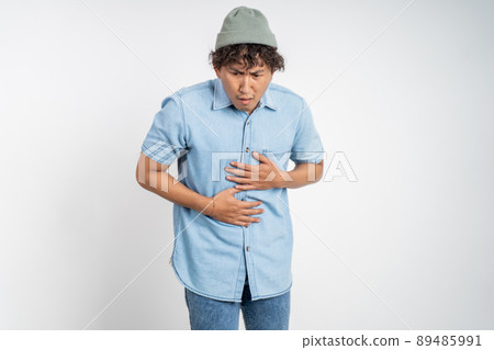 man having stomach ache on background isolated man having stomach ache on background isolated 89485991