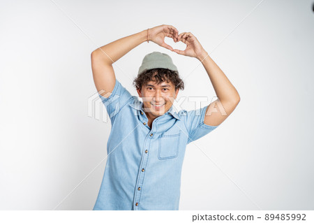 man forming a heart with finger gestures on isolated background man forming a heart with finger gestures on isolated background 89485992