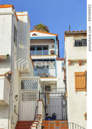 Apartment buildings with balconies and gates at San Clemente, California 89486602