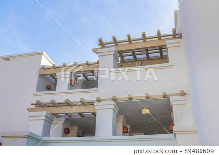Low angle view of a white building with timber awnings at San Clemente, California 89486609