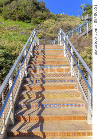Stairs with metal railings and tiles on steps and risers at San Clemente, California 89486651