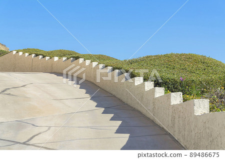 Concrete driveway with layered concrete wall at San Clemente, California 89486675