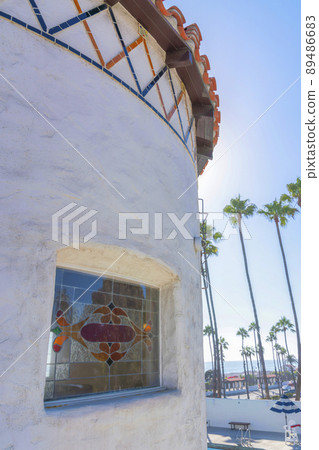 Window with ornate glass panes on a mediterranean style building at San Clemente, California 89486683
