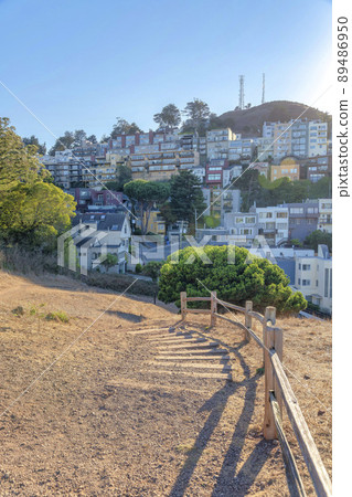 Trail on a hiking park in San Francisco, California with wooden barriers near the slope 89486950
