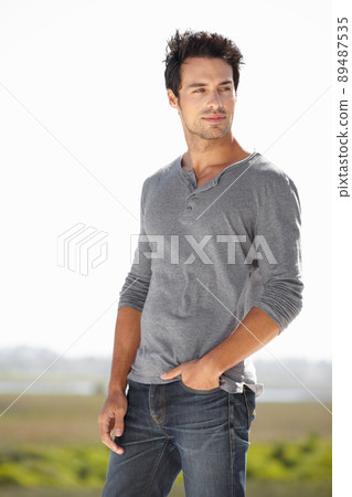 He knows hes got style. A handsome young man standing outside with his hands in his pockets. He knows hes got style. A handsome young man standing outside with his hands in his pockets. 89487535