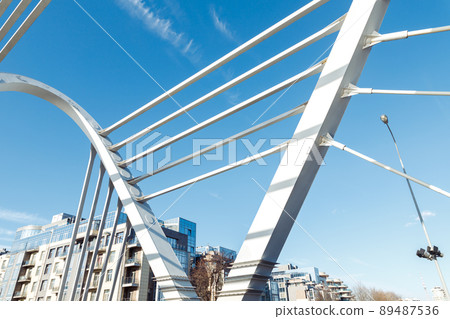 Lazarevsky Bridge is road metal cable-stayed bridge across Malaya Nevka river, Saint Petersburg, Russia. Cable stayed bridge supports, cable stays and blue sky, closeup 89487536