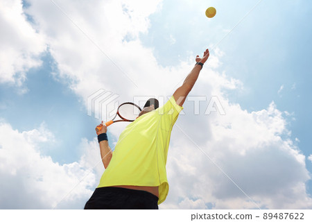 Hes king of the clay. Shot of a male tennis player about to serve. Hes king of the clay. Shot of a male tennis player about to serve. 89487622