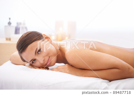 Enjoying some me time. A gorgeous young woman lying on a massage bed at the spa. Enjoying some me time. A gorgeous young woman lying on a massage bed at the spa. 89487718