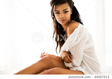 The key to my collection is sensuality. Portrait of a sexy young woman posing indoors. 89487813