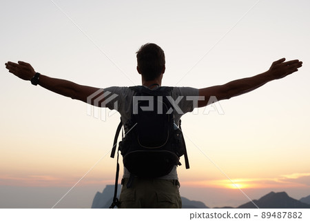 Finding his place in the world. Silhouette shot of a young man standing against the sky. 89487882