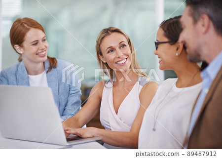 Getting the work done together. A diverse group of businesspeople using a laptop at a meeting. 89487912