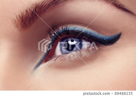 The eyes are the window to the soul. Close up of a blue eye with blue eyeliner. 89488135