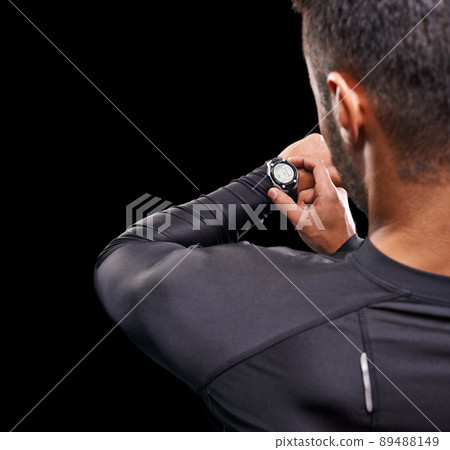 The clock starts now. Studio shot of a fit young man isolated on black. 89488149