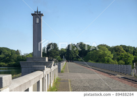 Promenade on the weir body of Yamaguchi Reservoir in the fresh green Sayama Hills 89488284