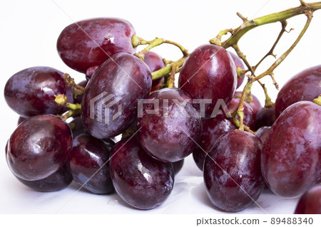 Bunch of red grapes on white background 89488340