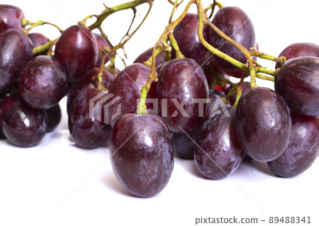 Bunch of red grapes isolated on white background Bunch of red grapes isolated on white background 89488341