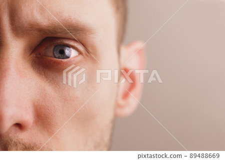 Young worried man with stern look. Close-up portrait half face 89488669