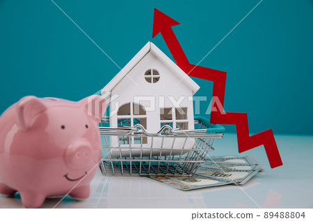House model, piggy bank and red arrow up close-up. The concept of inflation, economic growth, the price of insurance services House model, piggy bank and red arrow up close-up. The concept of inflation, economic growth, the price of insurance services 89488804