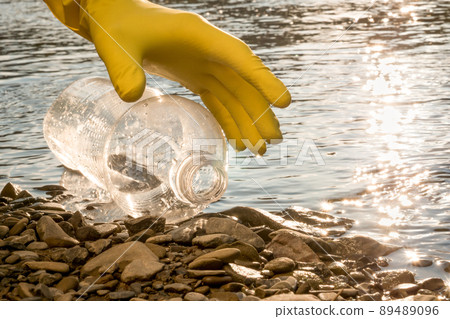 Volunteer cleaning river trash pick up litter picking shore. Collect garbage river. Picking up garbage water plastic nature. Cleaning trash beach garbage shore. Cleaning beach waste plastic bottle PET Volunteer cleaning river trash pick up litter picking shore. Collect garbage river. Picking up garbage water plastic nature. Cleaning trash beach garbage shore. Cleaning beach waste plastic bottle PET 89489096