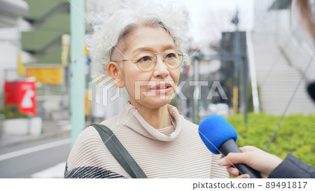 Senior woman undergoing a street interview 89491817
