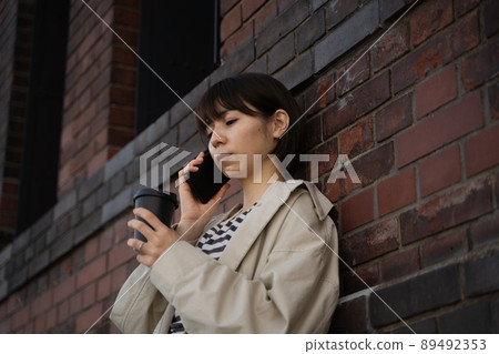 A woman talking on a smartphone 89492353