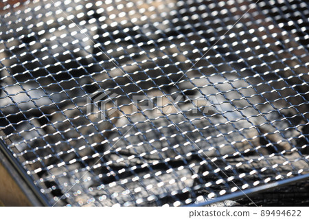 Net on the charcoal of the barbecue stove 89494622