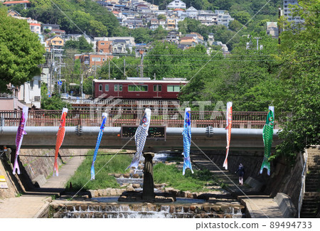 Hankyu Kobe Line Train and carp streamer crossing the Toga River Hankyu Kobe Line Train and carp streamer crossing the Toga River 89494733